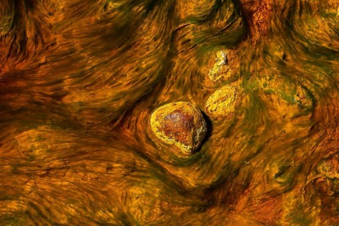 Close-up of the mineral-rich waters in Riotinto, Huelva, Spain, showcasing the vibrant orange and