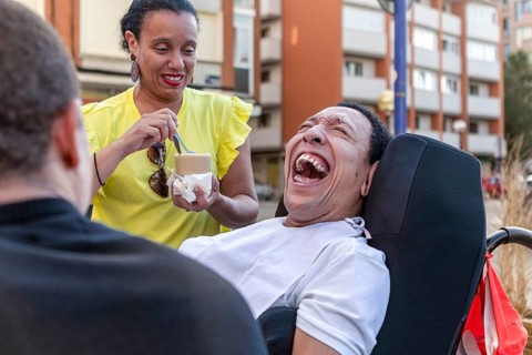 Mixed-race Spanish Cameroonian siblings share a joyful moment outside. One of the siblings, living