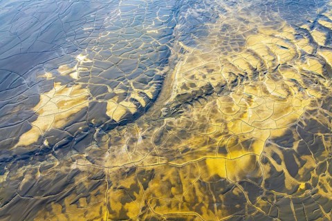 Aerial view of multicolor mud patterns, showcasing intricate textures and natural beauty The