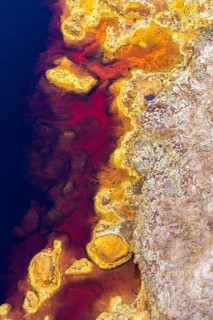 Aerial view of Riotinto River in Huelva, Spain, showcasing vivid red, orange, and blue hues The