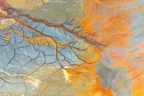 Aerial perspective of vibrant multicolor mud patterns and textures The image showcases natural,