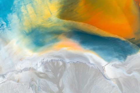 A vibrant abstract texture featuring a blend of multicolor swirls and organic patterns Rich blues,