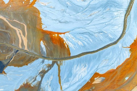 A vibrant abstract composition showcasing fluid textures in blue and orange shades The dynamic