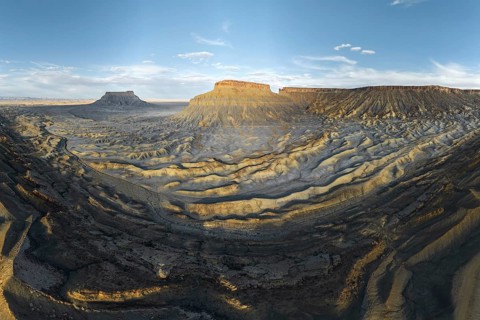 A breathtaking view of the rugged landscape of Caineville Mesa, Utah, USA, captured at sunset The