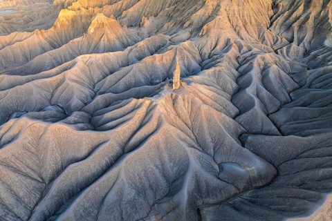 Sunrise lights up the layered hills of Caineville Mesa near Hanskville, Utah, highlighting their