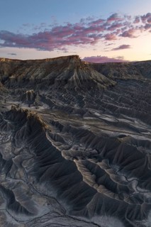 Dramatic view of Caineville Mesa in Utah at sunrise, showcasing unique geological formations and