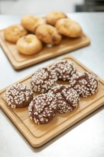 A charming Italian bakery setting with freshly baked cookies topped with sugar crystals and golden
