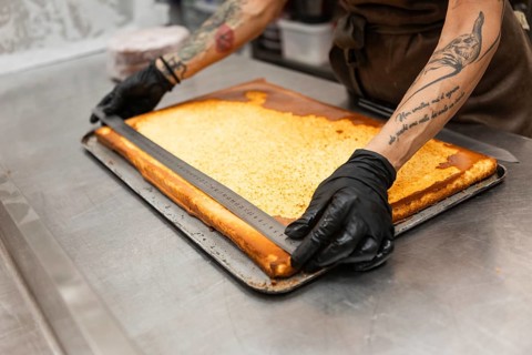 A baker skillfully measures pastry dough, showcasing precision in preparation The scene captures