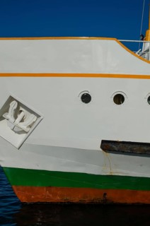 The bright colours of a ship's hull against a dark blue sky