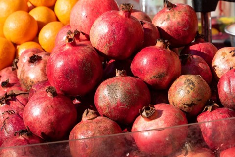 Brightly colored Pomegranates are juicy, sweet fruits with edible seeds called arils inside. A