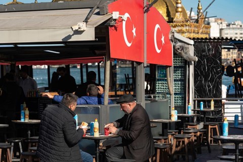 Istanbul, Turkey. November 21st 2023 Two Turkish men eat Balik Ekmek, a fish sandwich, a popular
