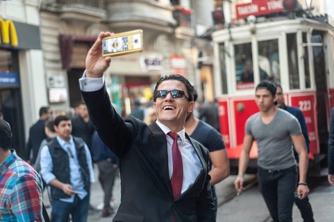 Istiklal Street, Istanbul, Turkey. March 27th 2016 A man in a business suit poses for a selfie in