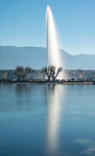 A tranquil shot of Geneva's iconic Jet d'Eau fountain, majestically rising above Lake Geneva
