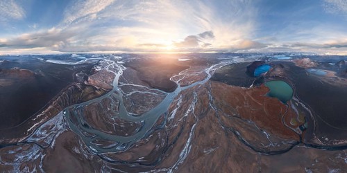 A breathtaking aerial view of Iceland's Highlands at sunrise, showcasing meandering rivers,