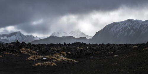 Majestic panoramic view of Iceland's highlands with volcanic terrain and distant snow-covered peaks