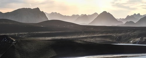 Captivating panoramic view of the Icelandic Highlands at sunset Mist gently blankets the mountains,