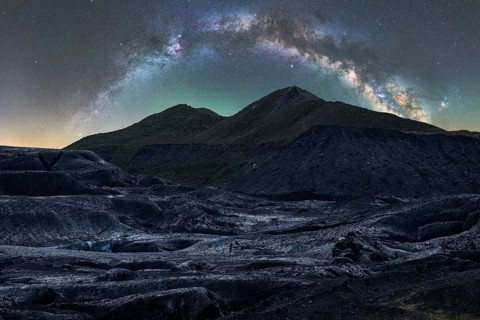Captivating Icelandic terrain under a stunning starry sky The Milky Way arcs gracefully above,
