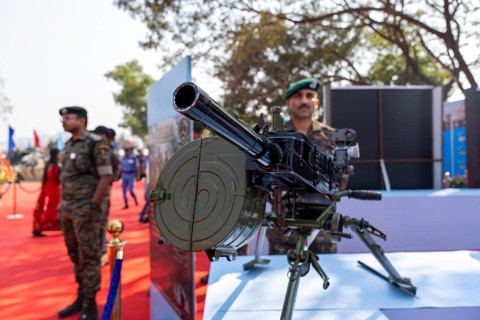 A heavy machine gun mounted on a tripod is displayed during a weapon exhibition by the Central
