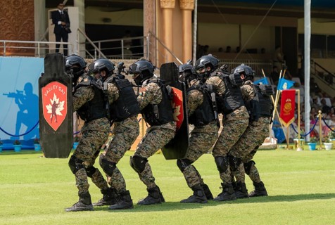 Personnel of the Valley QAT unit of the Central Reserve Police Force advance in shield formation