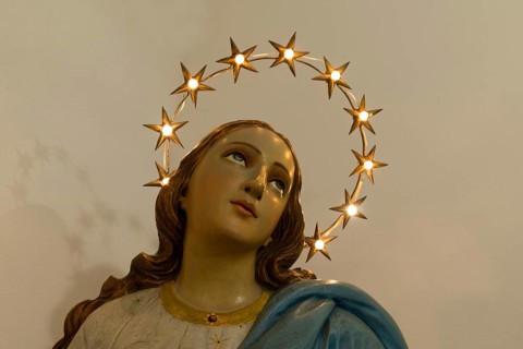 Wooden bust of St. Mary illuminated with a wreath of stars, Venice, Italy