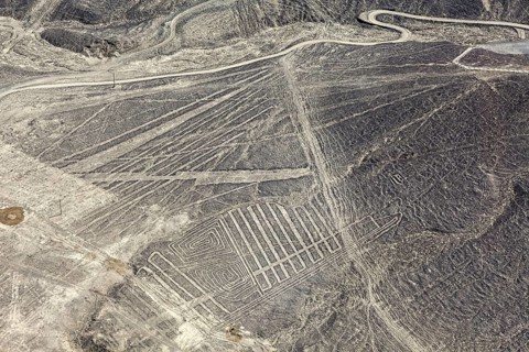 Aerial view of a desert region with numerous Nazca line patterns in Peru, the geoglyphs and images