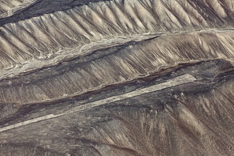 Aerial view of Nazca glyphs spanning sandy hills, the geoglyphs and paintings in the desert near