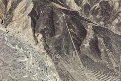 A mountainous country with a recognizable line pattern flying over the desert, the geoglyphs and