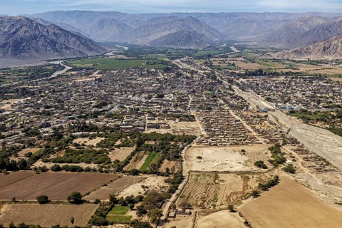 City seen from the air with surrounding fields and mountains in the background, clear panorama, The