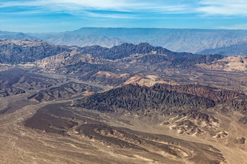 Hilly mountain landscape in a barren desert from a bird's eye view, The desert landscape near Nasca