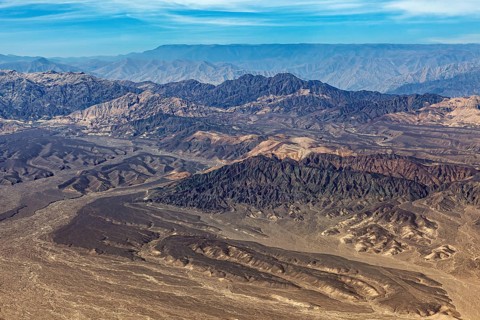 Barren mountain landscape in the desert with various shades of brown taken from above, The desert