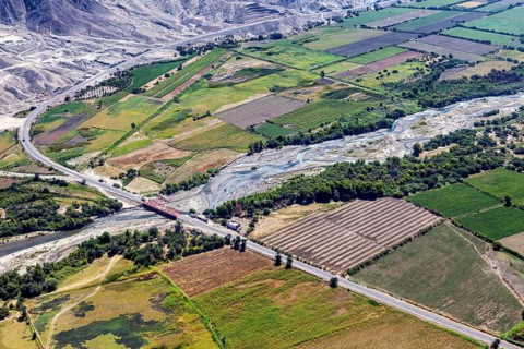 Picturesque green landscape with a river and a wooded road in the valley, The desert landscape near