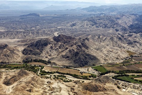 Landscape with mountains and green agricultural areas in the valley, The desert landscape near