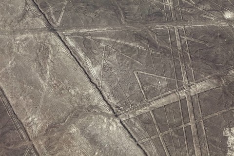 Geometric lines and patterns on a brown, dry desert surface, the geoglyphs and drawings in the