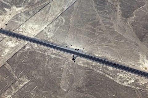 Road through a desert with ancient lines and shapes in the area, the geoglyphs and paintings in the