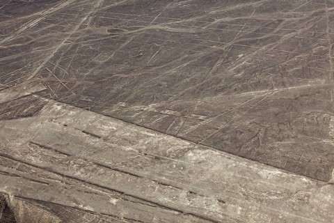 Nazca lines visible from the air with geometric shapes on barren desert soil, the geoglyphs and