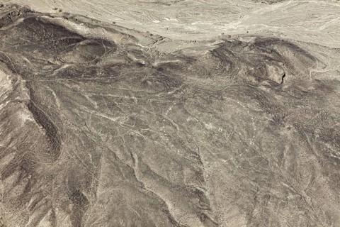 Extensive desert view with recognizable lines and patterns, the geoglyphs and images in the desert