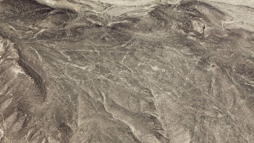 View of a dry desert area with recognizable ancient lines, geoglyphs and images in the desert near