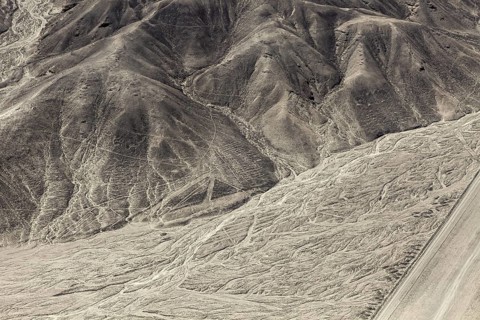 Hilly landscape with incised lines and patterns in the desert, the geoglyphs and drawings in the