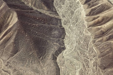 Aerial view of a hilly desert landscape with old patterns, geoglyphs and paintings in the desert