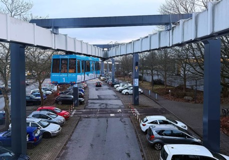 The H Bahn, an automatically controlled large cabin suspension railway above the parking lot of the