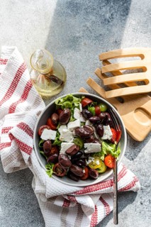 A vibrant Greek salad featuring juicy tomatoes, crisp lettuce, rich feta cheese, and olives,