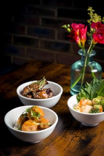 A styled display featuring tempura mushrooms in curry sauce and aubergine stew served over rice
