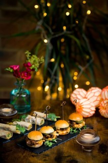 Beautifully styled dining presentation featuring vegetable and courgette rolls alongside pulled