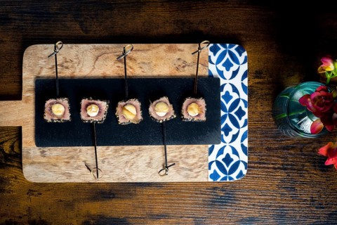 A top view of seared tuna skewers, with mayonnaise on an elegant platter The arrangement is