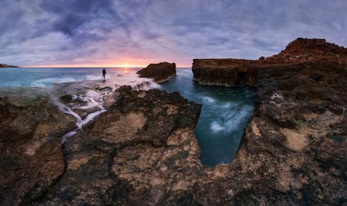 Captivating sunrise over rocky shoreline at Cabo Cervera in Torrevieja, Alicante, Spain A lone