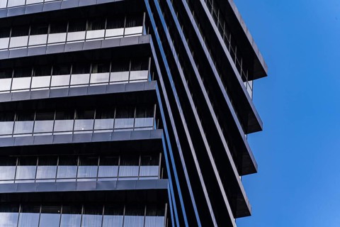 From below image highlights the geometric details of a modern skyscraper. The repeating patterns