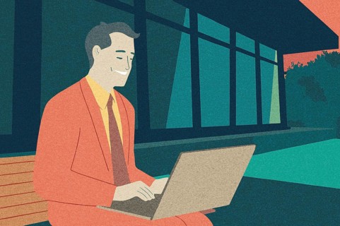 A business professional in a bright suit works on a laptop outside a contemporary building The