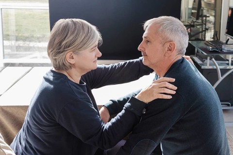 An elderly couple shares an intimate, tender moment in a cozy indoor setting The scene captures