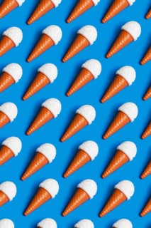 Vibrant pattern of plastic ice cream cones on a blue background, symbolizing critiques of junk food