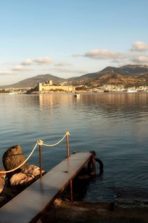 Beautiful morning light on Bodrum harbour with a medieval fortress and mountains in the background,